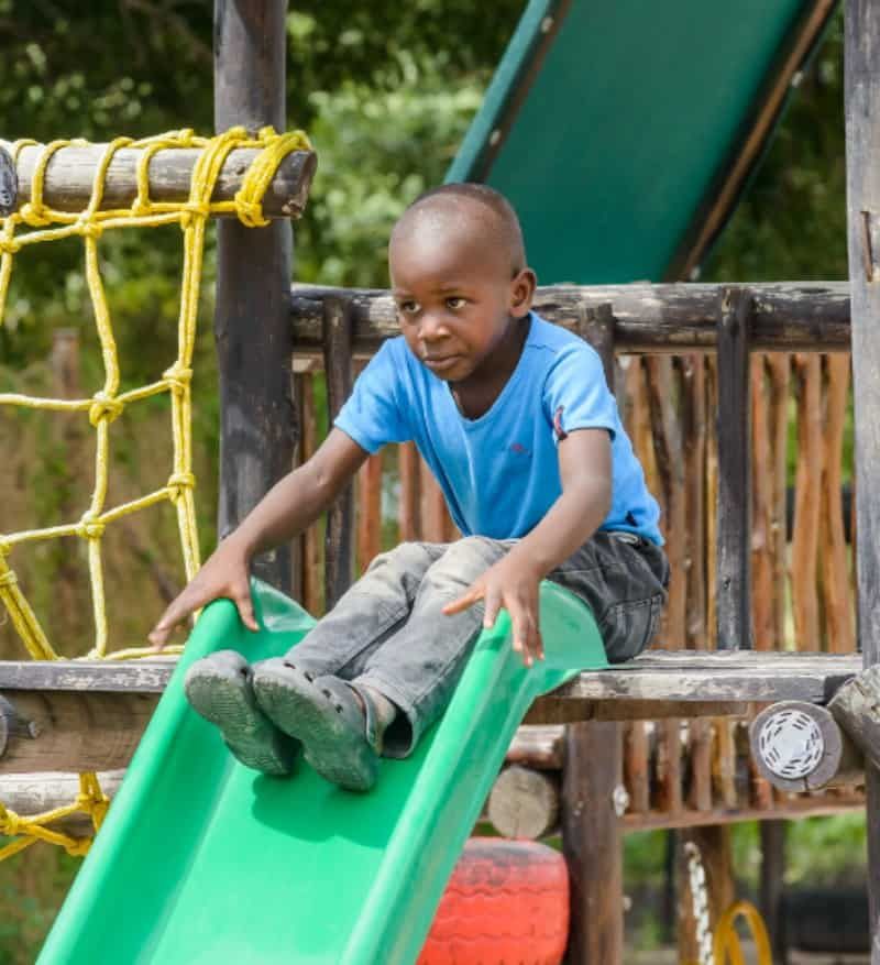Child at Tiyimiseleni Home Based Care Centre playground